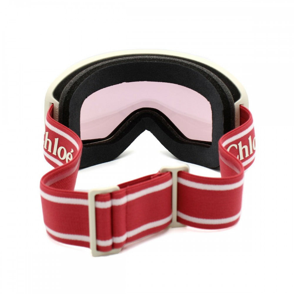 Ski goggles with red and white strap on a white background