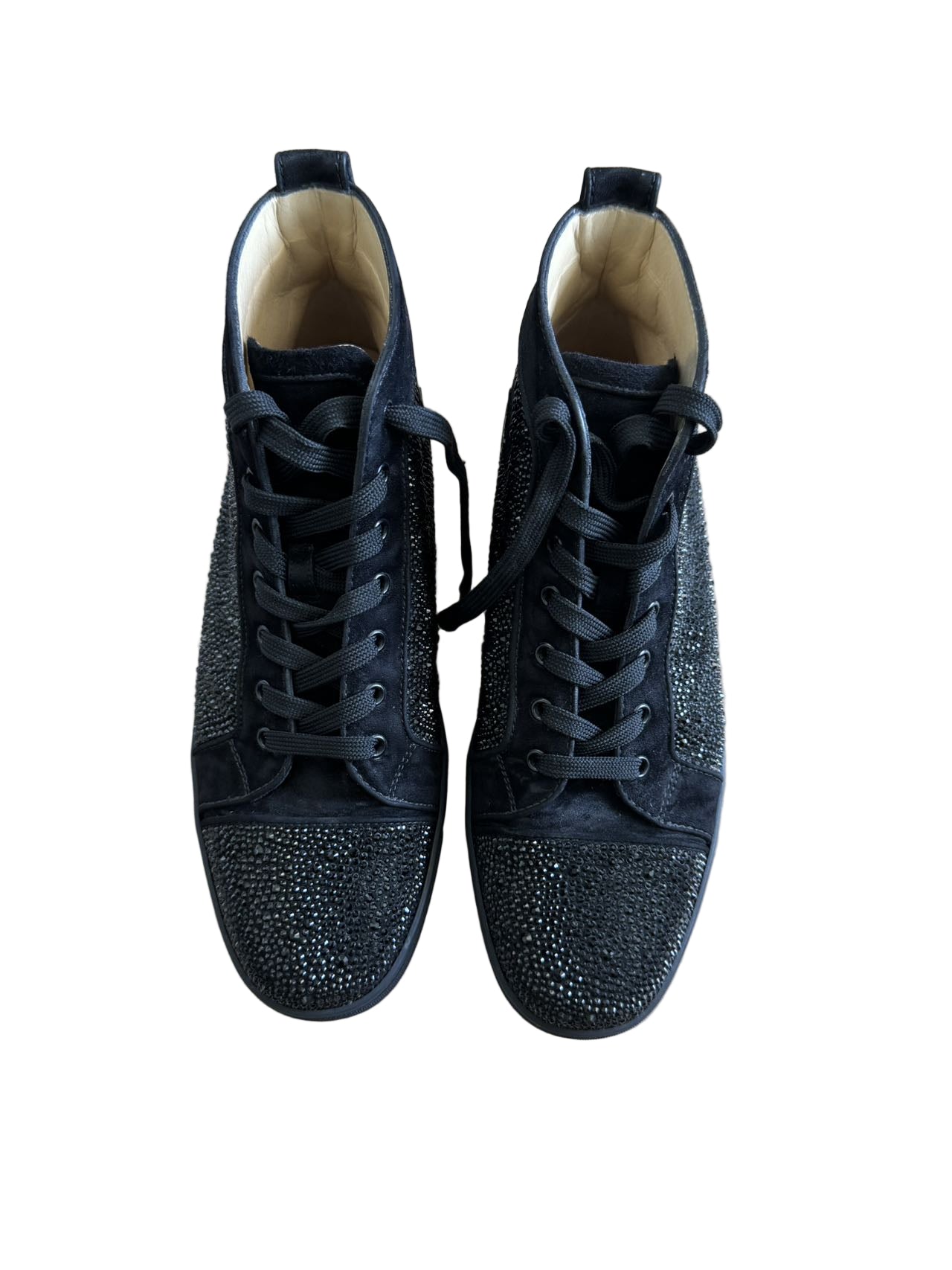 Pair of black high-top sneakers with rhinestone embellishments on a light wooden floor.