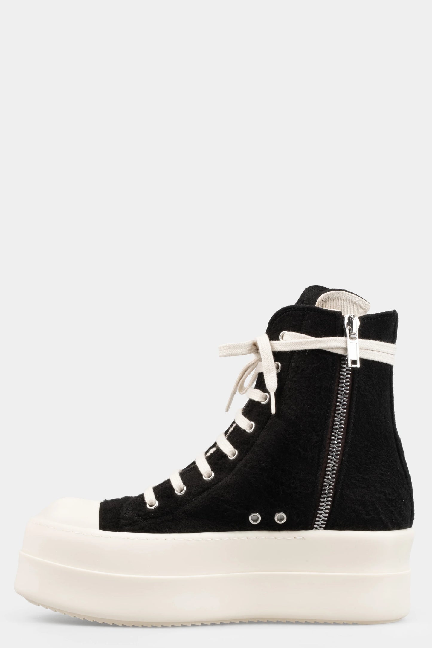 Black high-top sneaker with white laces and sole on a light gray background