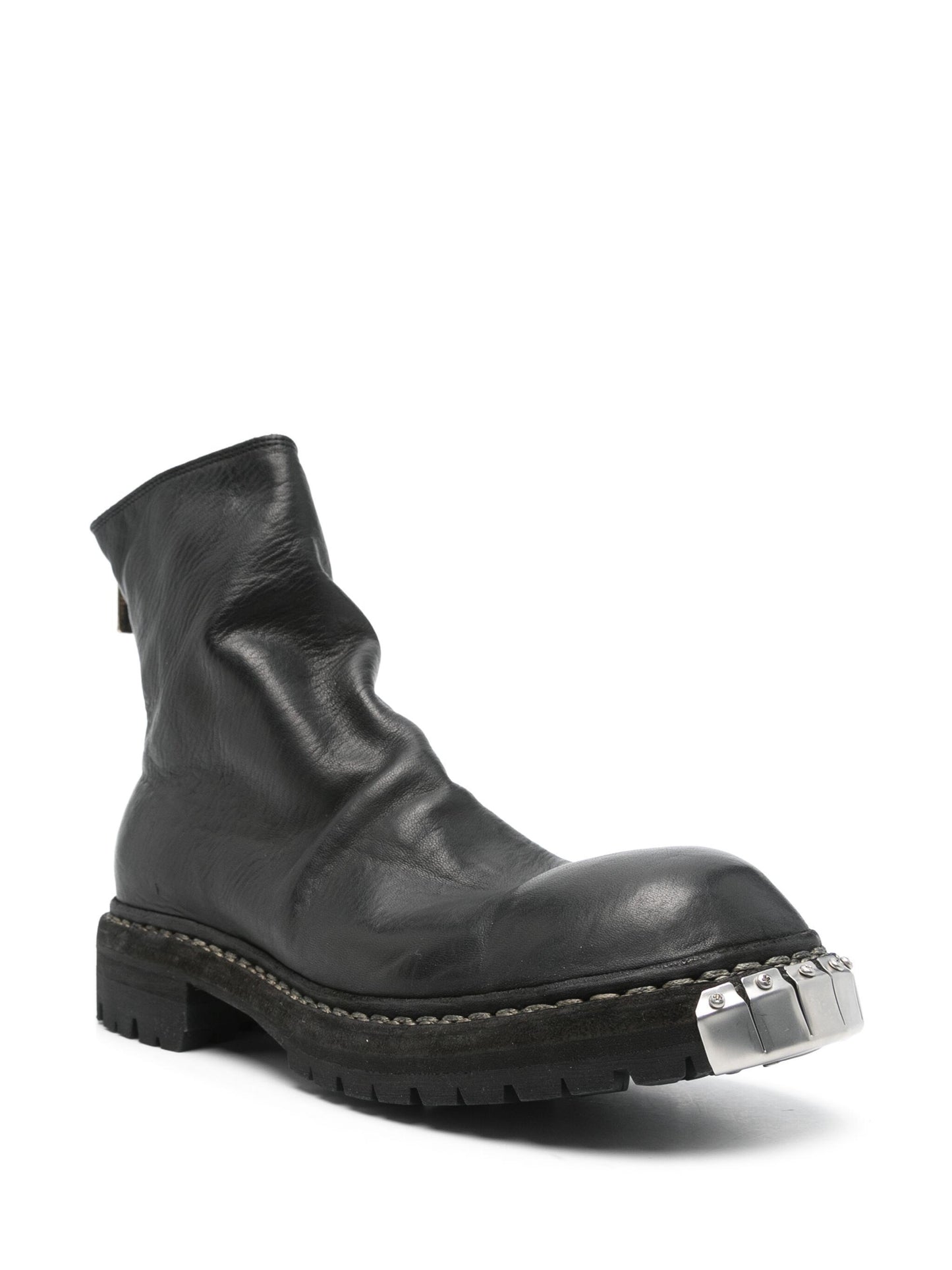 Black leather boot with a metallic buckle on a white background