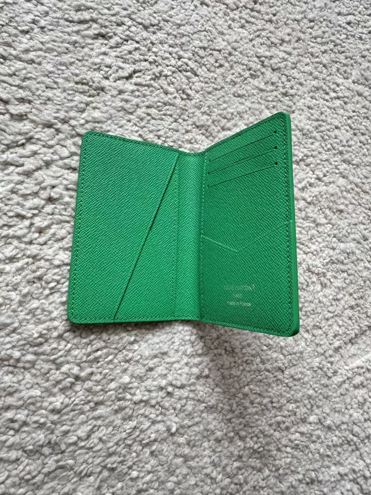 Green wallet on a gray textured surface