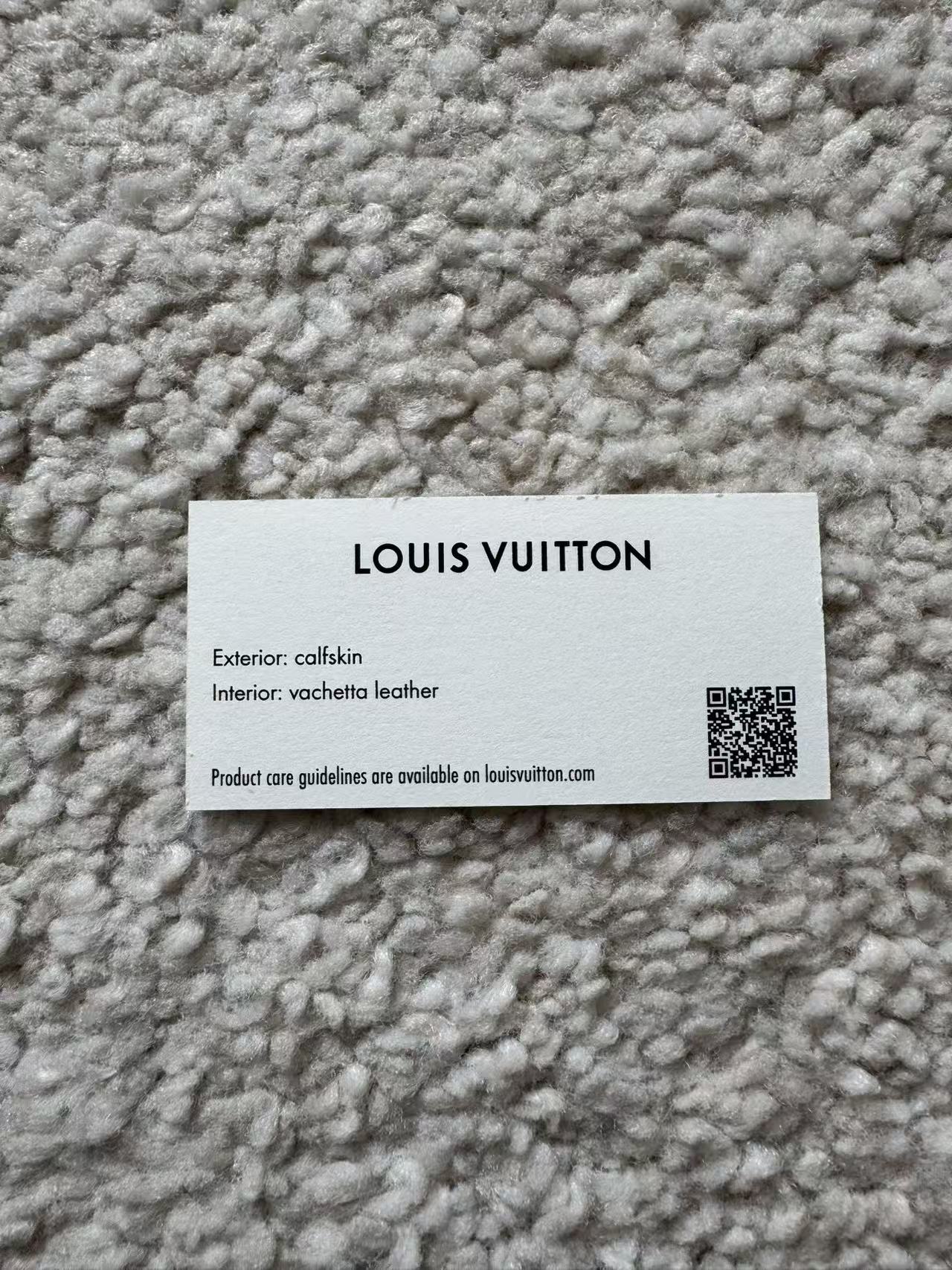 Louis Vuitton label on a textured fabric background