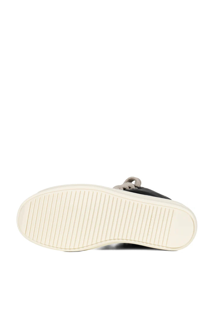Close-up of a shoe sole with white sole and black upper on a white background