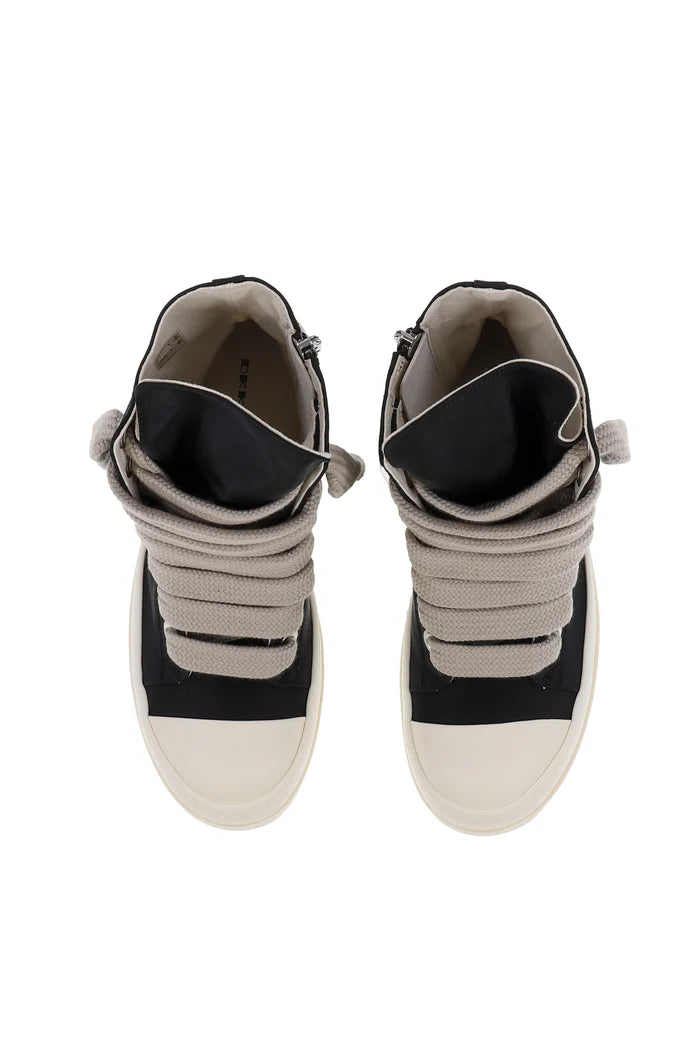 Pair of high-top sneakers with black and beige design on a white background