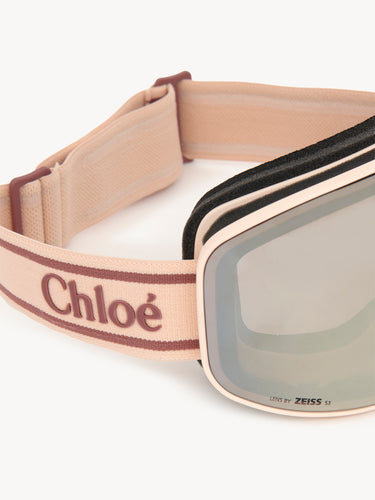 Close-up of a ski goggles with a beige strap featuring the brand 'Chloé'.