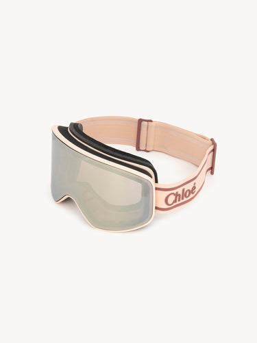 Ski goggles with a beige frame and Chloe logo on a white background