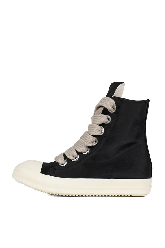Black high-top sneaker with white sole on a white background