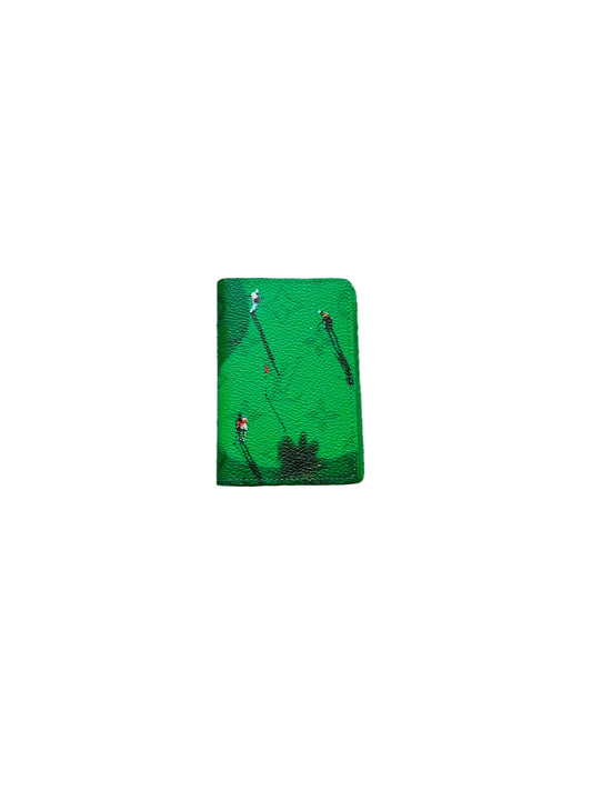 Green notebook with illustrations on a textured gray surface