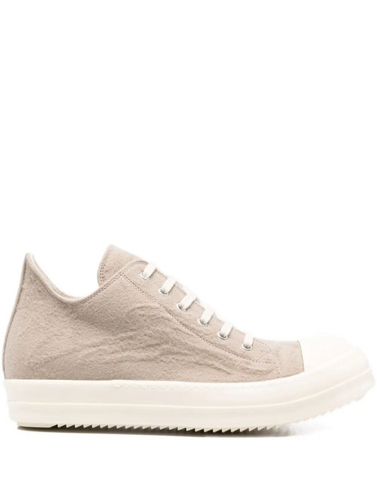 Beige sneaker with white laces on a white background