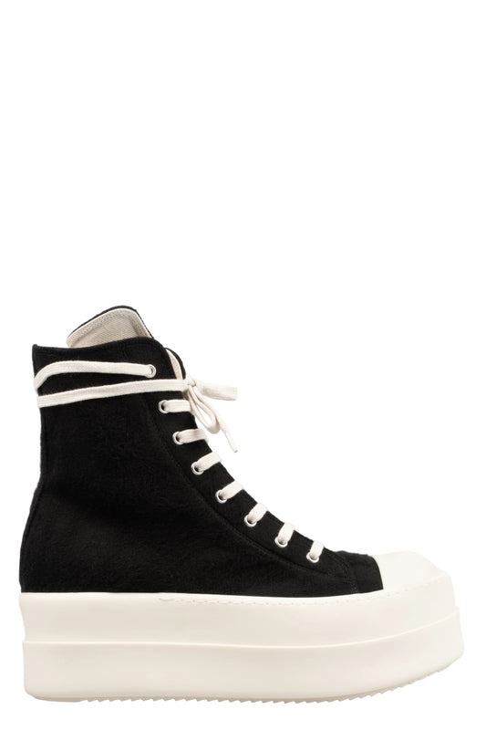 Black high-top sneaker with white laces on a light gray background