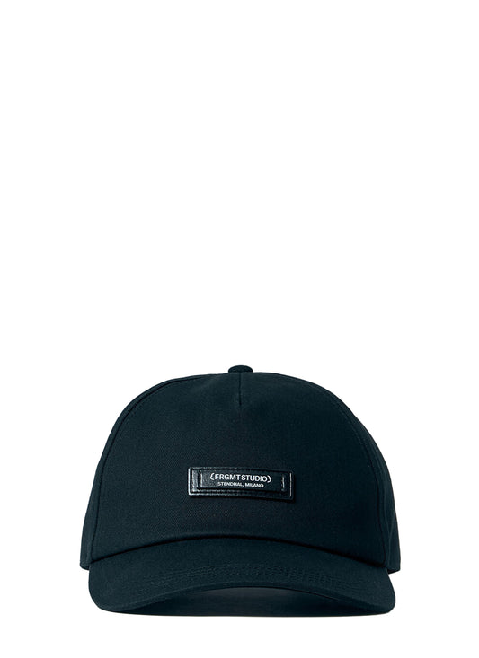 Black cap with a brand label on a light blue background